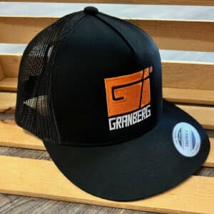A Granberg Snap Back Mesh Hat (Black) is displayed on a wooden chair.